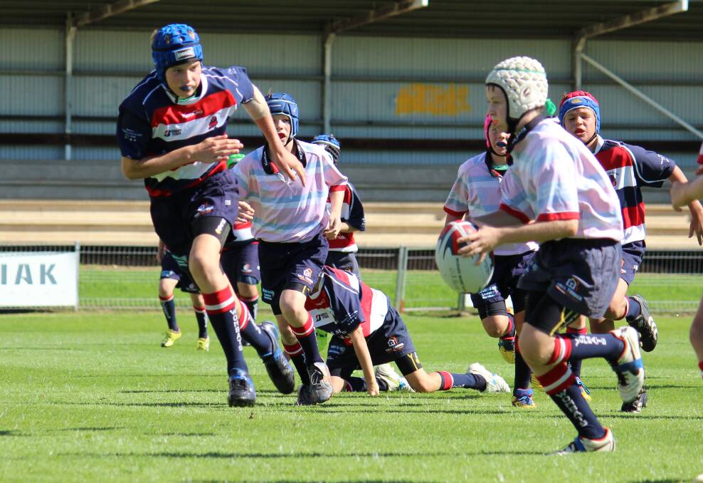 Ben Wall-Robson makes a break for the Mudgee Wombats under 13s Blue on Saturday at Jubilee Oval. PHOTO: DARREN SNYDER