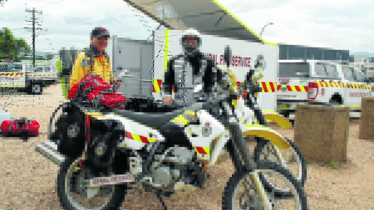 Captain of Cudgegong Rural Fire Service RAFT team Jamie Hudson and firefighter Chris Toovey with the trail bikes which will be located at Cudgegong Rural Fire Service over the coming weeks as part of state-wide trial.