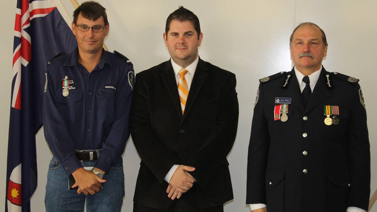 Jason McWhirter received the long service medal for 18 years service as a member of the Boothenba, Mudgee HQ, Narooma, North West Orange and Wollar brigades, he is pictured with Mid-Western Regional Council Deputy Mayor Cr Paul Cavalier and NSW RFS Assistant Commissioner Stuart Midgley.