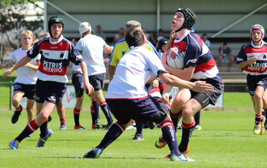 Mudgee Wombats under 15s Red player Alex Saint meets the Blue defence on Saturday at Jubilee Oval. PHOTO: DARREN SNYDER