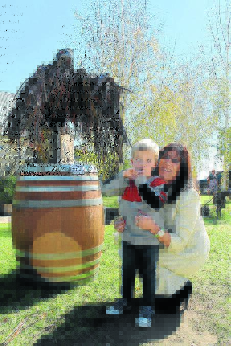 Linda Field with her grandson Ronan and her bark-feathered Wedgetail Eagle. 