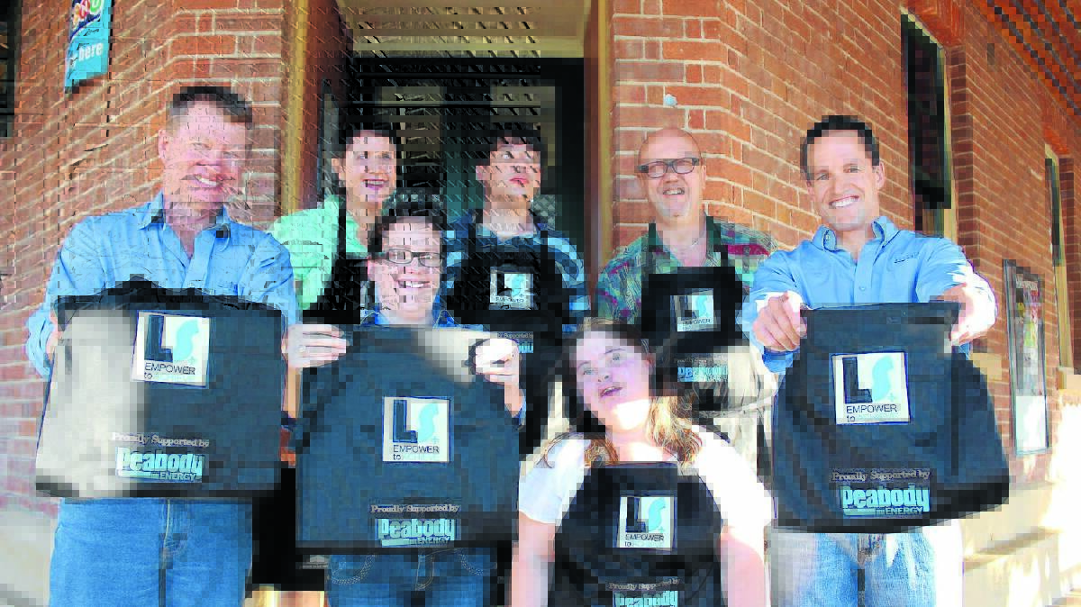 Wilpinjong general manager Blair Jackson, Kelllie Smith and Kieren Bennetts with Lifeskills clients Jess Plant and Sam Naake (behind) alongside Lifeskills manager Sonya Pym and business and community liaison Bob Lejeune. Lifeskills clients and staff will be decked out in new aprons supplied by Wilpinjong whilst selling raffle tickets at Lawson Park Hotel every Thursday.