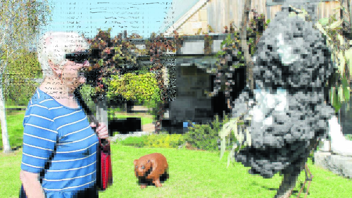 Patricia Feast comes face to face with the koala made from steel wool by Lifeskills Southside.