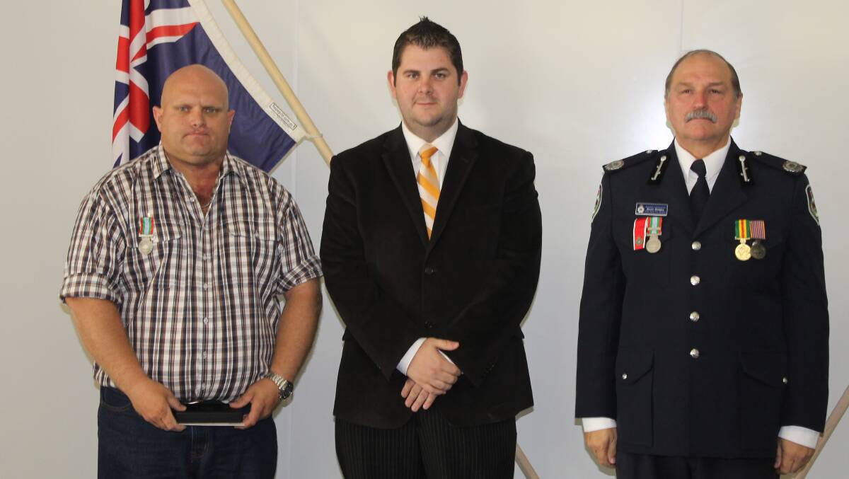 Michael Boyland received the long service medal for 18 years service as a member of the Rylstone and Mudgee HQ brigades, he is pictured with Mid-Western Regional Council Deputy Mayor Cr Paul Cavalier and NSW RFS Assistant Commissioner Stuart Midgley.