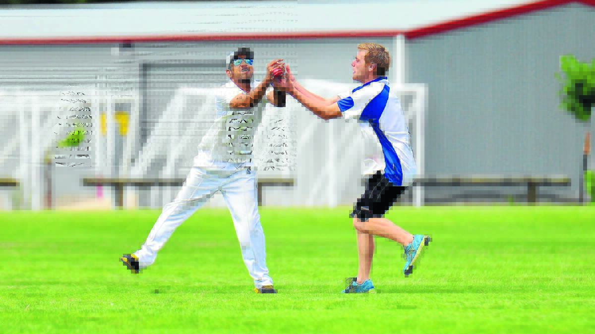 Two Woolpack Hotel players go for the one catch. Photo: COL BOYD