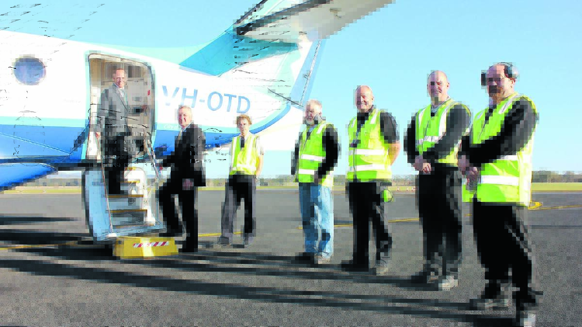 FlyPelican CEO Paul Graham and Mid-Western Regional Council general manager Brad Cam with ground crew at Mudgee Airport ahead of their first flight in June, 2015.