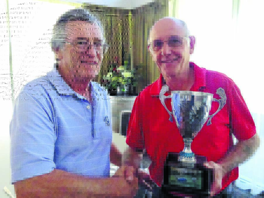 David Halpin presents Rod Wilson with Ewan Burgman trophy on Tuesday.