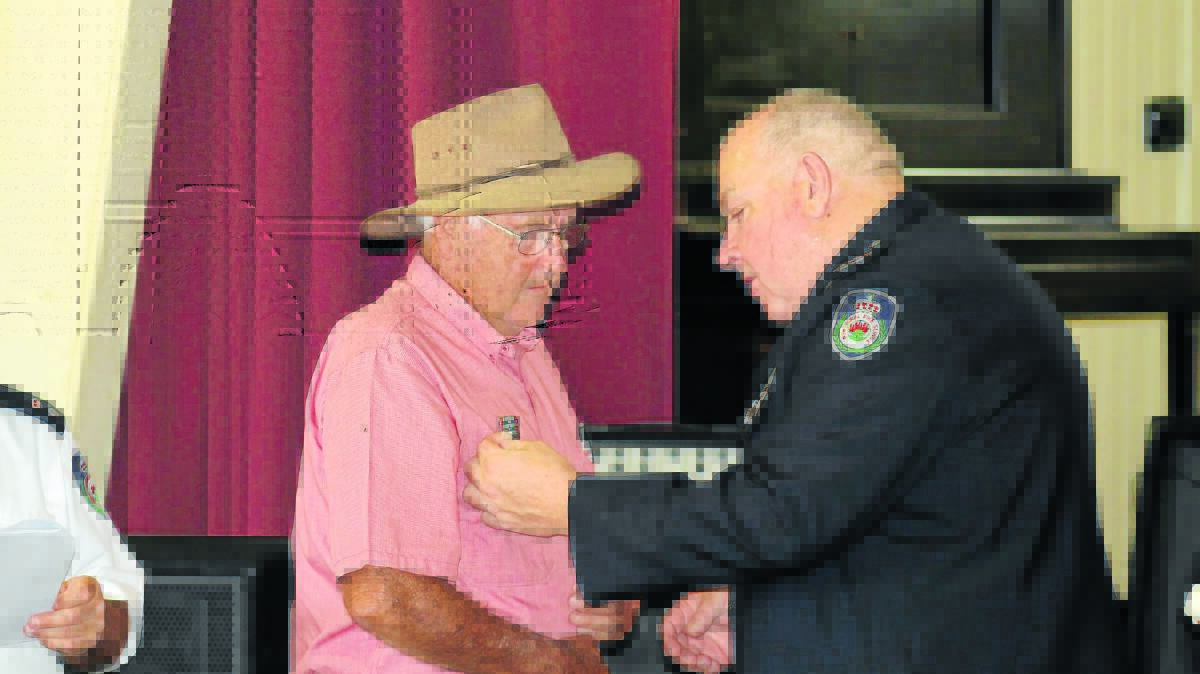 The Cudgegong RFS District will hold their long service medal presentation this Saturday. Pictured is NSW RFS Assistant Commissioner Bruce McDonald presenting Ilford/Running Stream Rural Fire Brigade volunteer Ian Moore with his long service medal at the brigade’s ceremony late last year.