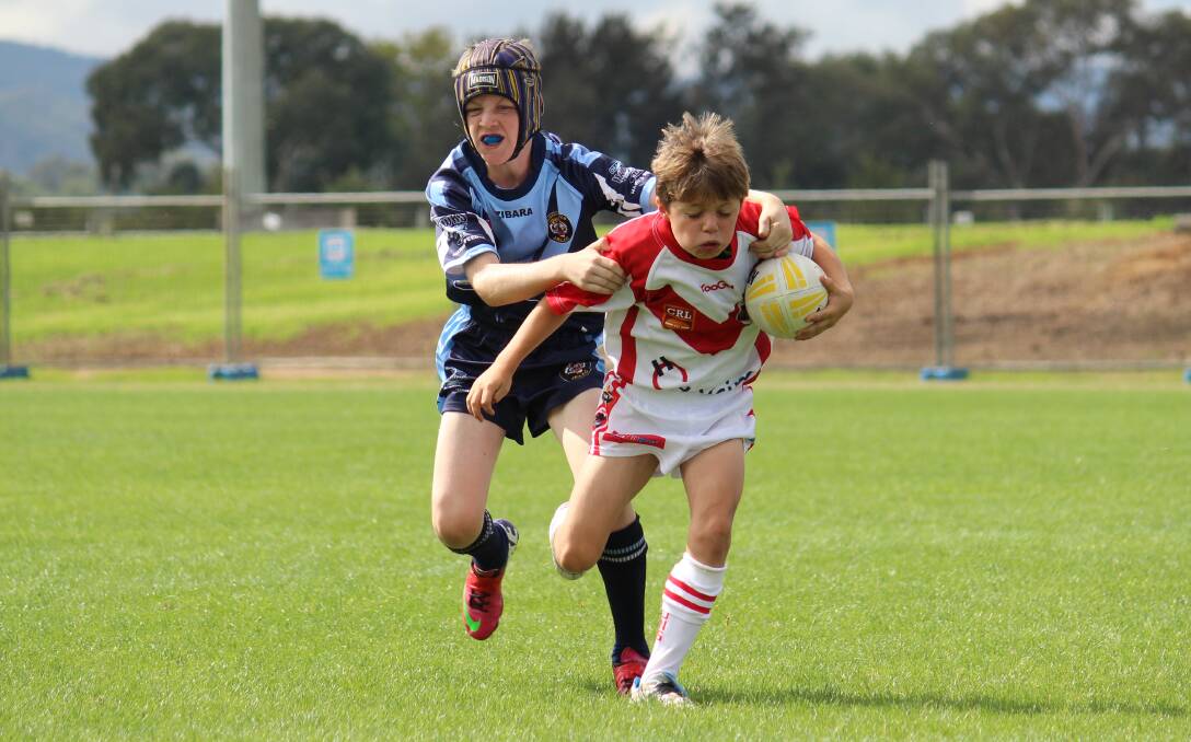 Mudgee's Josh Clay tries to escape the Bloomfield defence in under 11s rugby league on Saturday. PHOTO: DARREN SNYDER