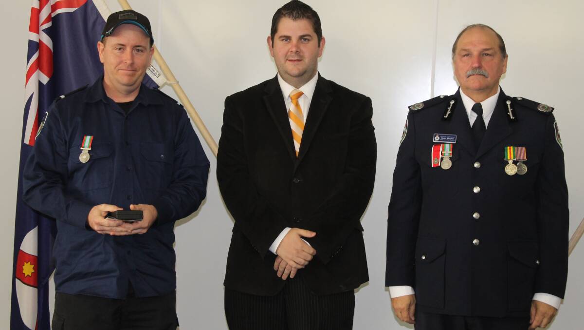 Tim Knowles of the Cooks Gap Brigade received the long service medal for 11 years of service, he is pictured with Mid-Western Regional Council Deputy Mayor Cr Paul Cavalier and NSW RFS Assistant Commissioner Stuart Midgley.