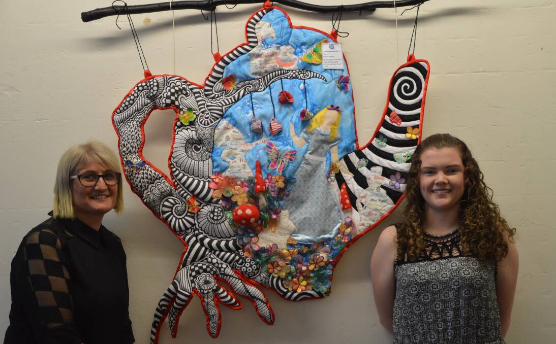 WONDERFUL: Textiles and Design teacher Cheryl Murray with HSC student Bridget Baskerville and her marvellous ‘Alice in Wonderland’ wall hanging.