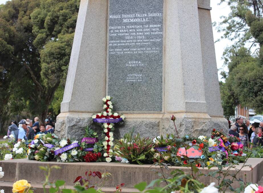 LEST WE FORGET: The Mudgee cenotaph was adorned with wreaths, flowers, images and messages in memory of the Anzac heroes and veterans.