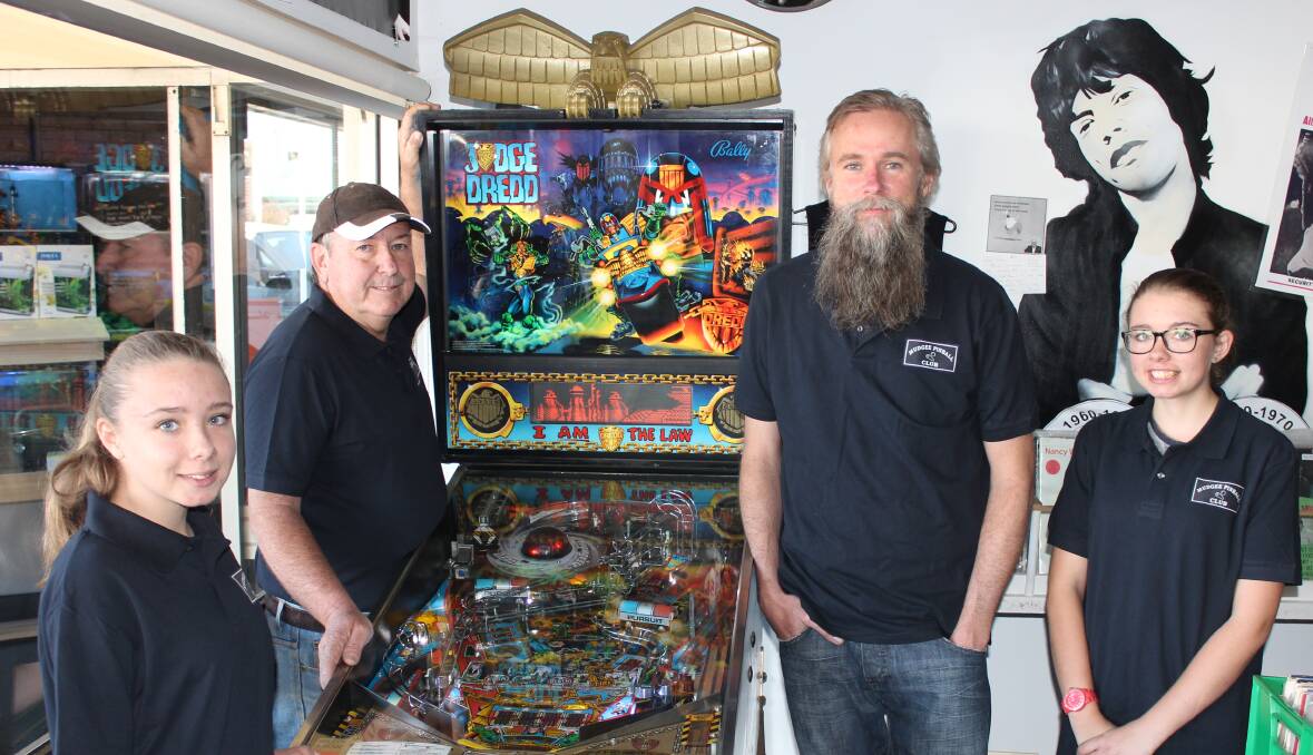 Members of the Mudgee Pinball Club, Vicky Parkinson, Larry Parkinson, Craig Dykes and Kelly Parkinson with the Judge Dredd machine.
