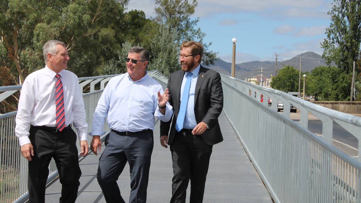 Mid-Western Regional Council General Manager, Brad Cam with Mayor Des Kennedy and Member for Dubbo, Troy Grant taking the first official steps on the new Holyoake Footbridge.