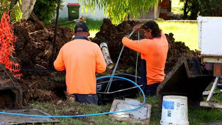 Contractors roll out the NBN in NSW. Work has halted in the Victorian town of Ballarat and is under threat in Tasmania due to contract disputes. Photo: Domino Postiglione