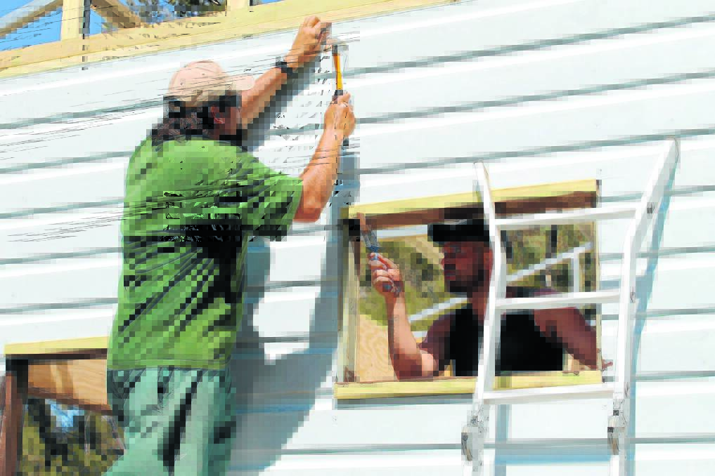 Louis hammers in boards while Joseph paints the bird hide’s window frames. 	041012/putta bucca/1