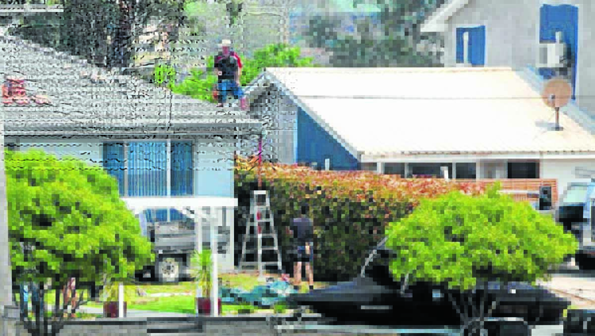 RESPONSE:  The roof of a house in Henry Bayly Drive is repaired after the neighbour’s carport blew onto it on Thursday night: