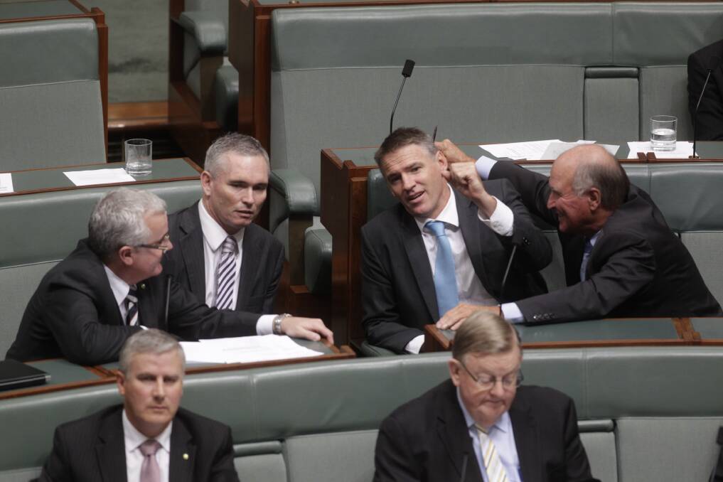 Independent MPs Andrew Wilkie Craig Thomson Rob Oakeshott and Tony Windsor talk during the motion if no confidence during question time at Parliament House in Canberra. Photo: Fairfax Media