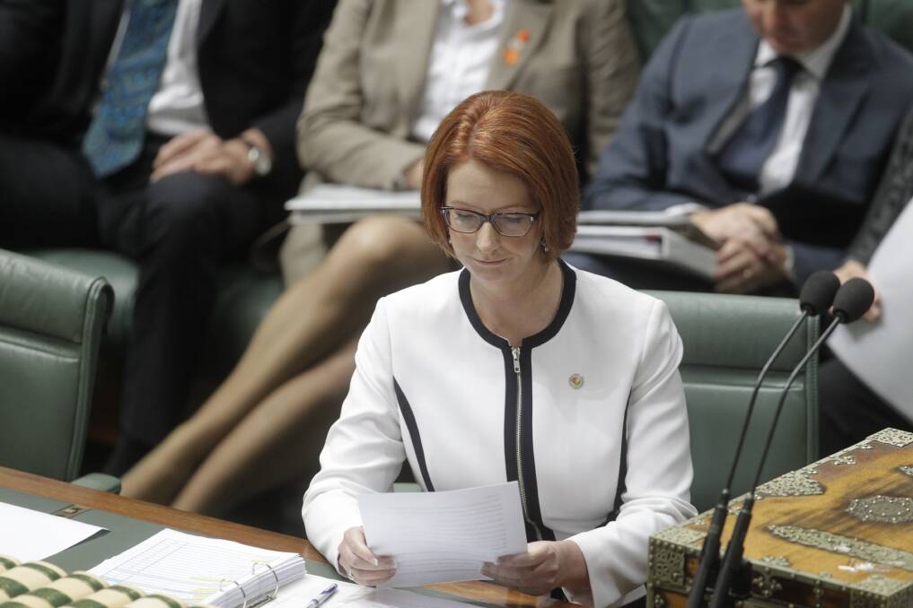 Prime Minister Julia Gillard listens to Opposition Leader Tony Abbott move a motion of no confidence during question time at Parliament House in Canberra. Photo: Fairfax Media