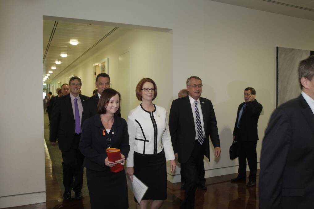 Prime Minister Julia Gillard walks out of the Caucus meeting retaining her leadership title. Photo: Fairfax Media