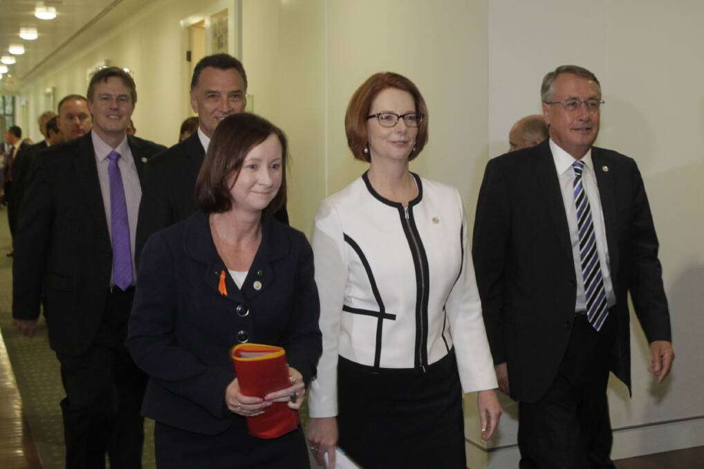 Prime Minister Julia Gillard walks out of the Caucus meeting retaining her leadership title. Photo: Fairfax Media