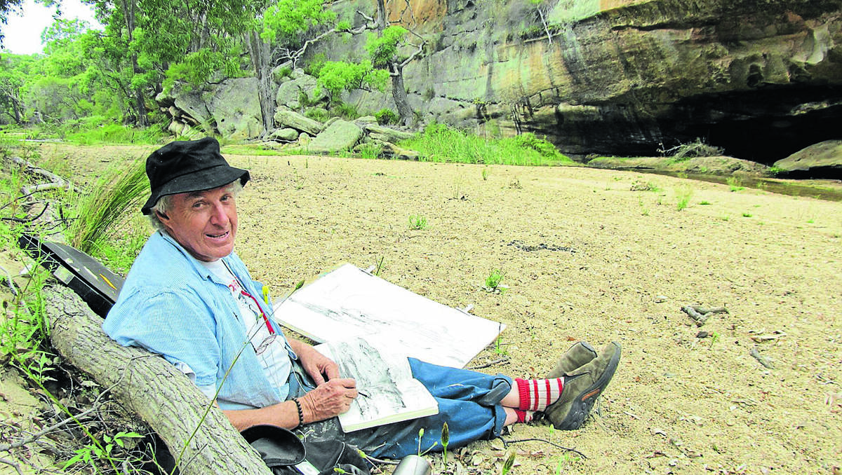 Peter Kingston drawing at The Drip Gorge on Saturday, near where Brett Whiteley created a mural on an overhanging cliff.