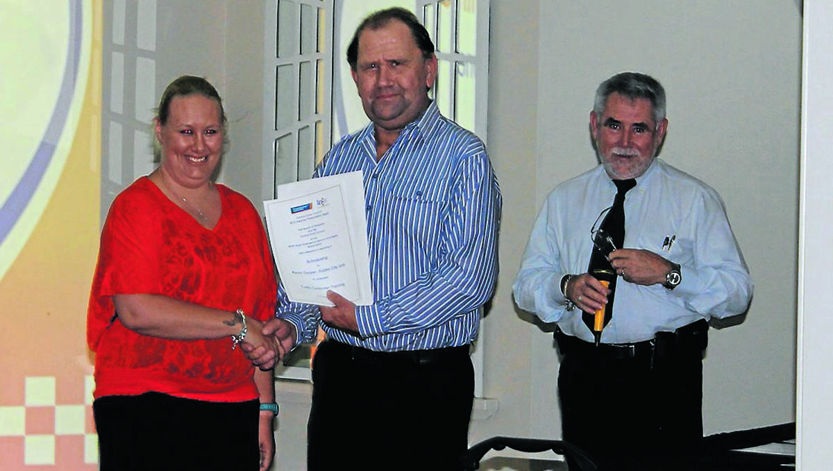 SESVA Macquarie Representative and Local SES Unit Controller Ian Forrester and SESVA Vice Chairman and Council Chairperson for Central Zone Peter Lalor, present Dubbo Unit representative Karen Cowper with a scholarship at the SESVA Central Zone Presentation Night in Mudgee on Saturday.