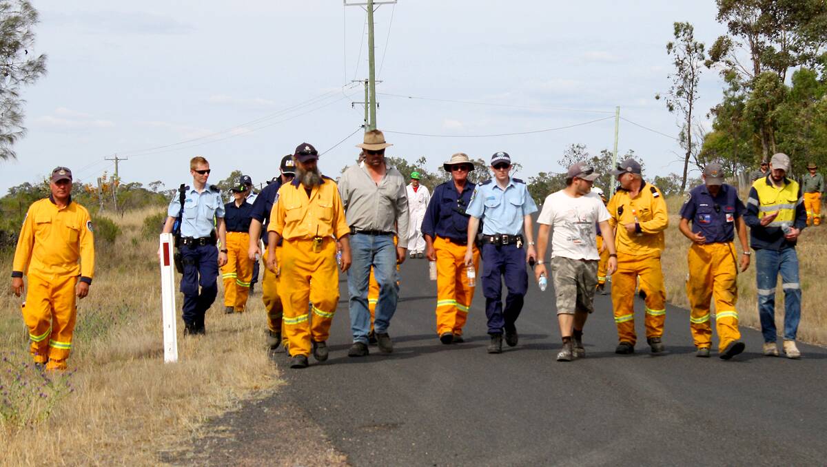 Searchers including Police, State Emergency Service, Rural Fire Service and Volunteer Rescue Association volunteers and neighbours return from a line search on Friday afternoon.