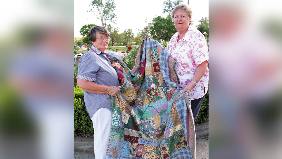Bugaldie resident, Chris Munge, who lost her home in the bushfires, was the first recipient of a quilt presented to her by Baradine CWA president, Nea Worrell.	131213/ChrisMungequilt