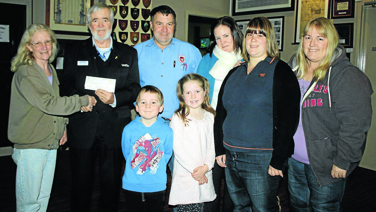 Caerleon Court resident Cheryl Maxwell presents a cheque for $6432 to Careflight community engagement officer John Ebbott, watched by neighbours Peter, Annette, Kylie and Sue Mitchell, and Natalie and Liam Standen.