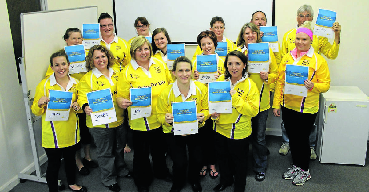 Members of the 2014 Mudgee and District Relay For Life organising committee pledge their support for the Cancer Council’s ‘Harmful Not Helpful’ campaign. Pictured are (back, from left) Mel Heldon, Kellea Rayner, Maureen Bennett, Mark Sabin, Ian Hunter, (middle from left) Trey Smith, Gemma Toole, Hayley Gray, Gabrielle Condon, Rebbecca Stoddart, (front, from left) Heidi Stott, Debbie Degoumois, Kris Morrison, Tanya McPherson, Hayley Gray, and Rebecca Redfern.