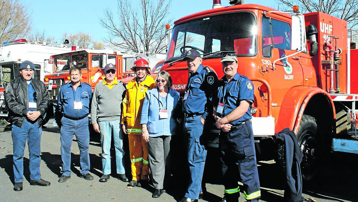 Cudgegong RFS Heritage group members Bill Burns, Barrie Hewitt AFSM, Brian Wells, Barry Wells, Pam Hewitt, Alan Selwyn and Phillip Pedley with part of their collection of heritage firefighting vehicles on display at the Rural Fire Association (RFSA) conference on the weekend.