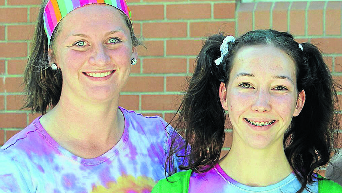 Sarah Fergus and Alice Wisse get into the spirit outside their sausage sizzle store. 210912\Rainbow Day 14a