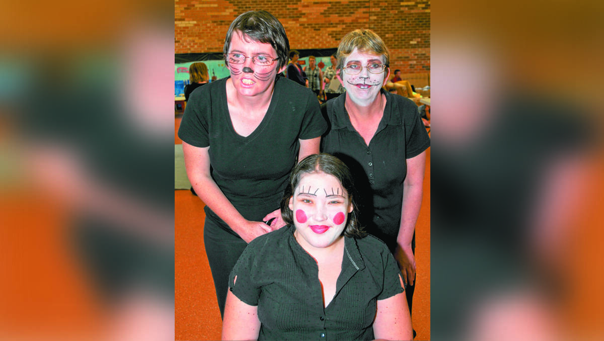 Cindy Barton, Susie Downing and Maddie McCarthy in make up for Mudgee Disability Support Service’s production of Alice in Wonderland during March. PHOTO BY SANDY SMITH