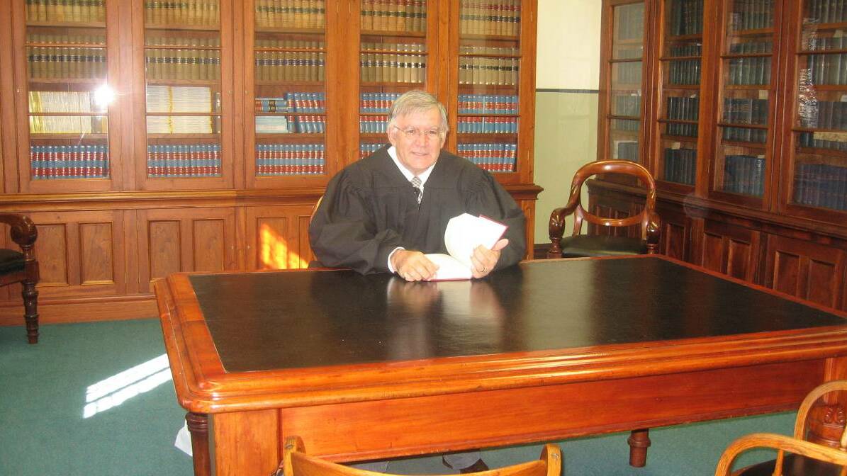 Wollongong magistrate Darryl Pearce donning his black robes when he was aged 72. Picture from file