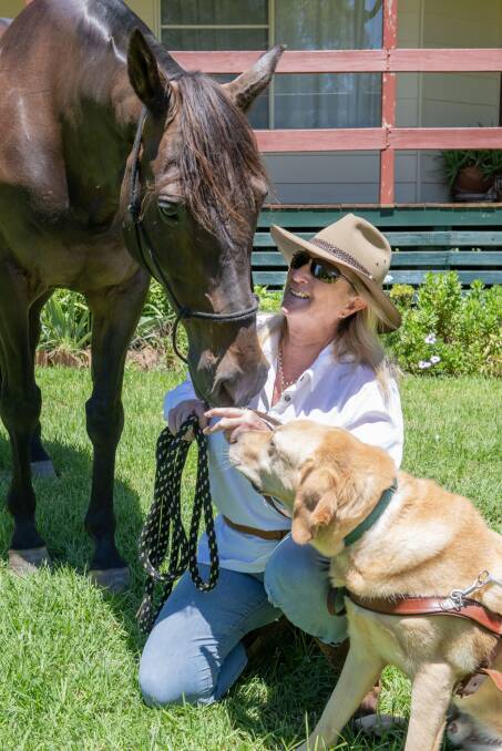 Paralympian Sue-Ellen Lovett with her horse, Oliver, and guide dog, Woody. Picture by Belinda Soole