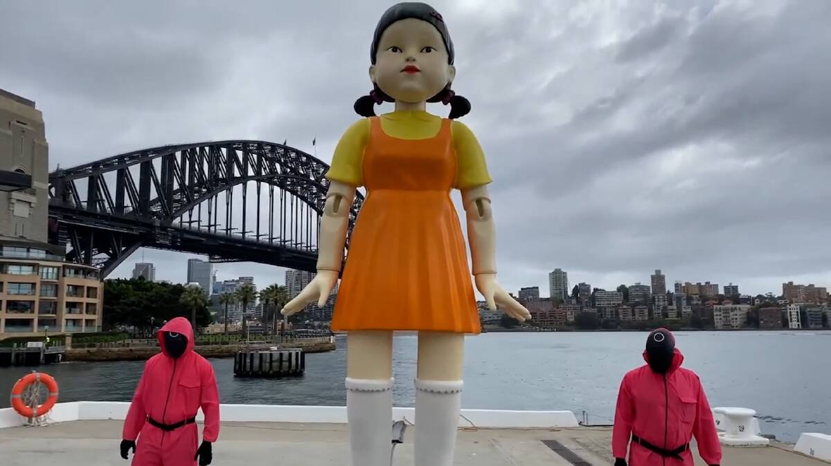 The 4.5-metre-tall doll, which is a replica of one seen in the Netflix series, first appeared at The Rocks in front of the Harbour Bridge on Friday and brought in huge crowds over the Halloween weekend. Photo: Hahn Solo, Facebook. 