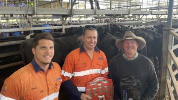 Peabody Coal's James Heesterman and Ian Flood present Andrew White, Havilah North, Mudgee, with the trophy for the best pen of females. The cows and calves made $2800. Pictures by SImon Chamberlain