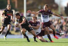 Penrith star Nathan Cleary, pictured trying to avoid Manly's Jake Trbojevic and Daly Cherry-Evans at Carrington Park in 2021, will play this Saturday. Picture by Phil Blatch