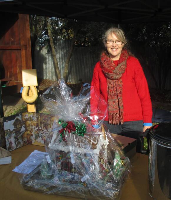 Yum: Agnes Nordmann with the beautiful gingerbread house made by Pamela Matheson. Raffled to raise funds for Gulgong Public School.