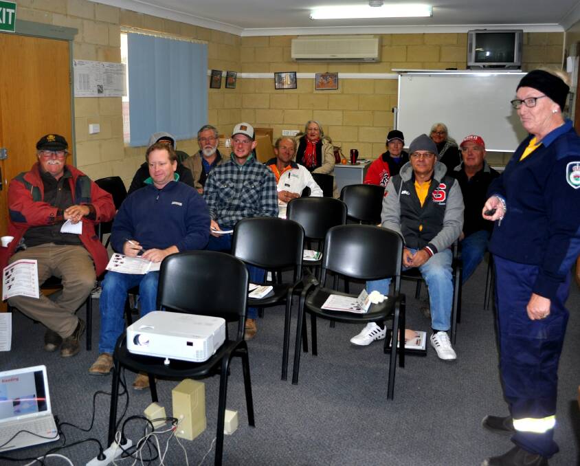 Lovely Learning: Sue Duggan instructing the RFS members in the Rylstone Fire Shed. 