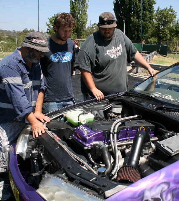 Hot: Competitors Daniel Falzon with Gerry and Guy Clare checking out the Clare’s Ford EF Falcon, a winner at the Sydney Dragway’s Burn Out Mania in October. 