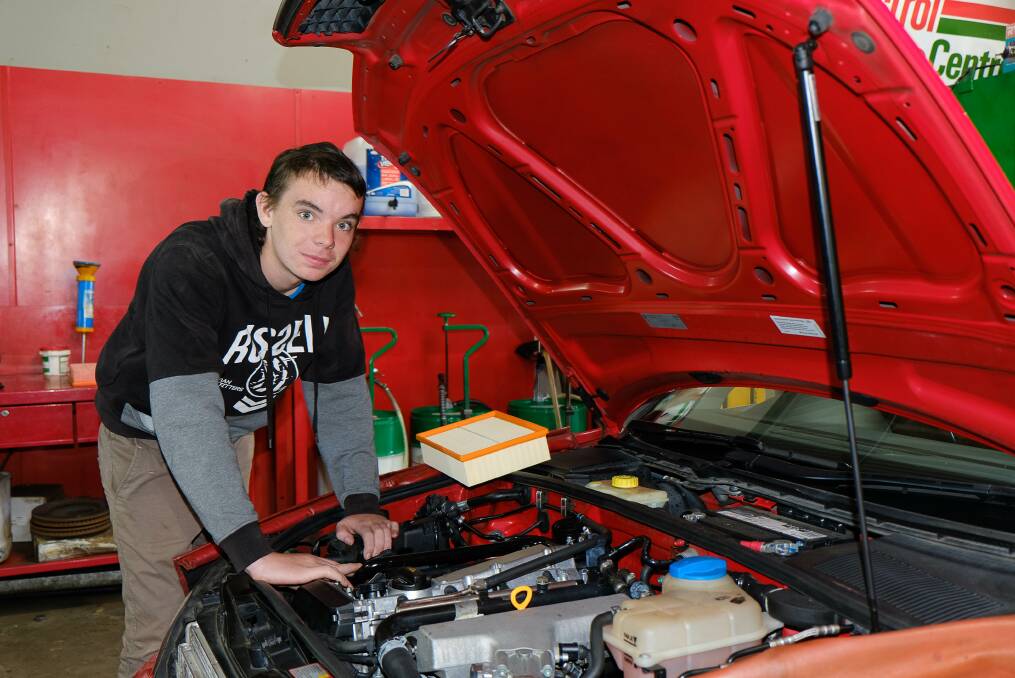 THE RIGHT TOOLS: Mudgee High School student Jack Hundy inspects an engine at Gladstone Street Mechanical Services, where he has undertaken work experience. Photo: CONTRIBUTED