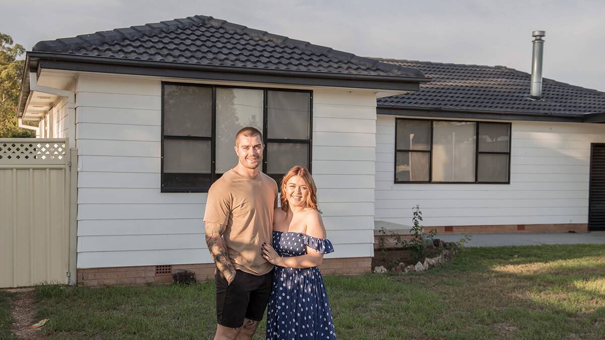 Molly Bailey and her partner Michael Radford outside their new home. Photo: Callan Lawrence 
