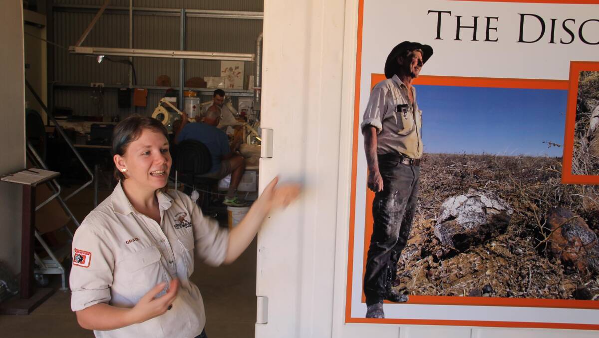Grace Elliott … one of the Australian Age of Dinosaurs museum’s senior tour guides, with a poster featuring David Elliott. 