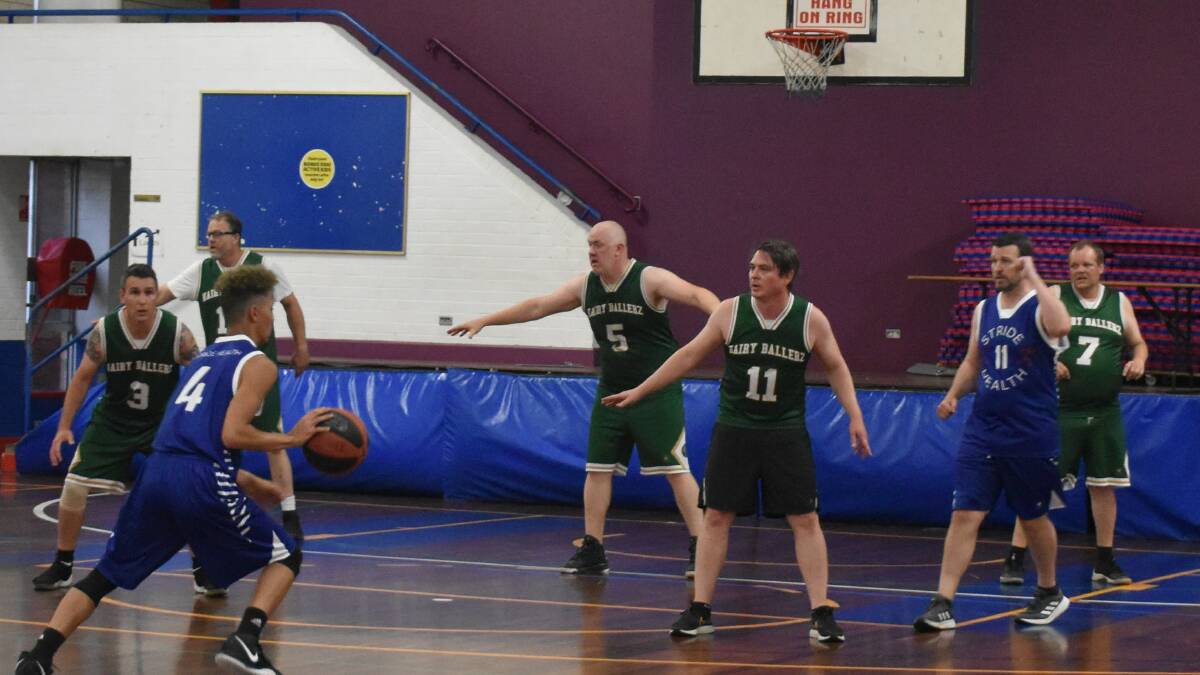UNSTOPPABLE: Stride Health's Lachlan Mitchell (4) driving for a lay up against the Hairy Ballers defence Martin Howes (3), Peter Doran (5), Henry Mowat (11). Photo: Supplied