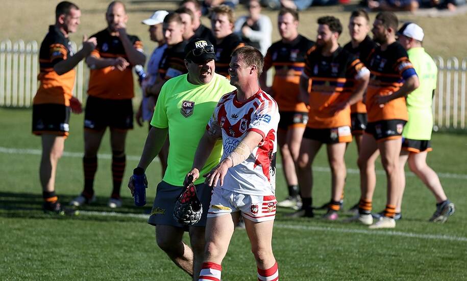 CAN'T DO IT WITHOUT: Trainer Ben Gregory accompanies Dragons' Jared Robinson off the field. Photo: BJ's Mobile Photography Mudgee