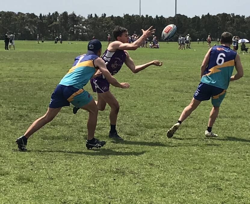 MIGHTY MUDCRABS: Mudgee's Cody Lawson making a pass in between two Jerrabomberra players. Photo: Supplied