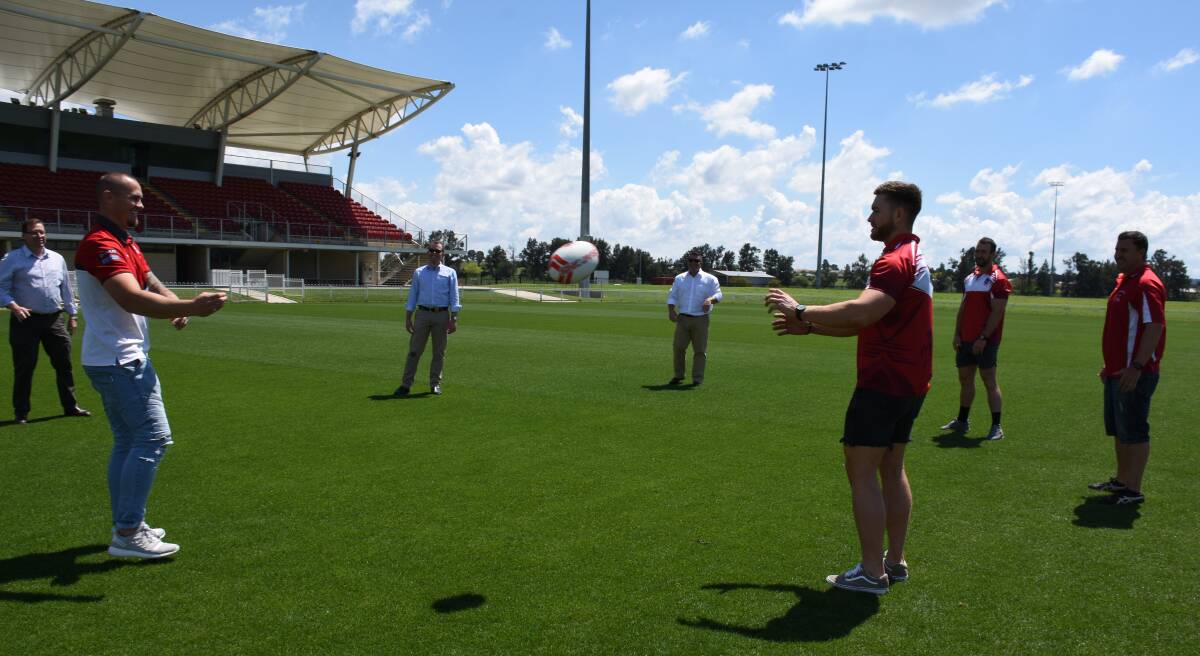 DRAGONS: Matt Cooper having a throw with three Mudgee Dragons players, Troy Grant, Dugald Saunders and Adam Marshall. Photo: Jay-Anna Mobbs