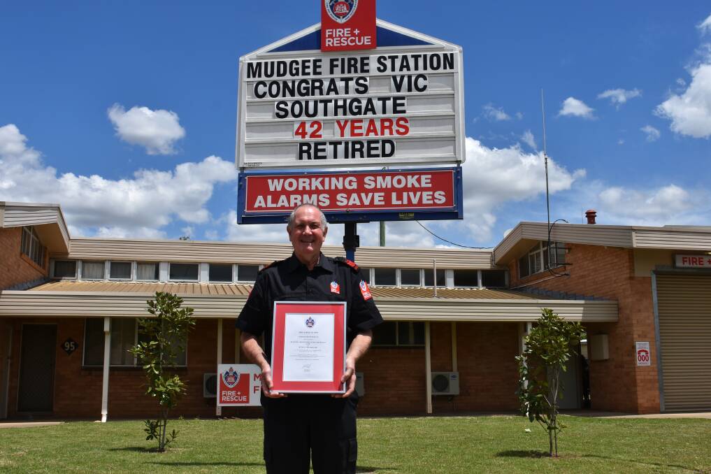 RETIRED: Vic Southgate holding his Certificate of Service in front of the Mudgee Fire Brigade station. Picture: JAY-ANNA MOBBS